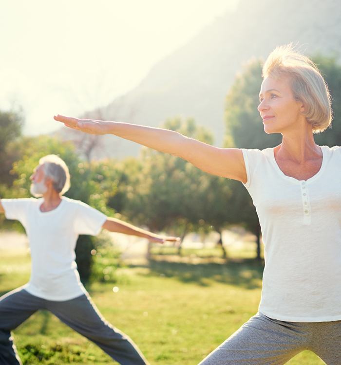 Senior couple exercising outside, enjoying benefits of biologic cell therapy