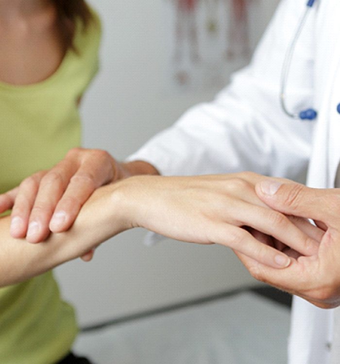 doctor examining woman with Carpal Tunnel Syndrome