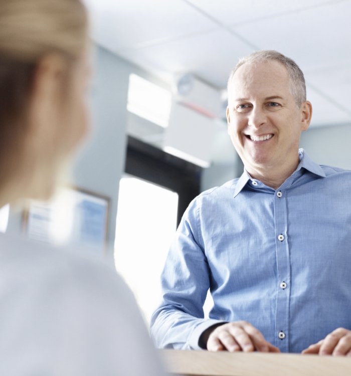 patient at front desk with receptionist