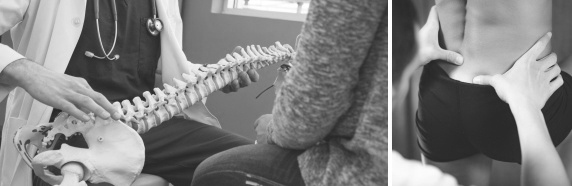 Doctor using skeletal model to help patient understand spinal alignment