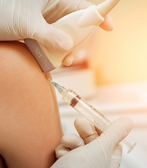 Doctor placing regenerative medicine injection in knee