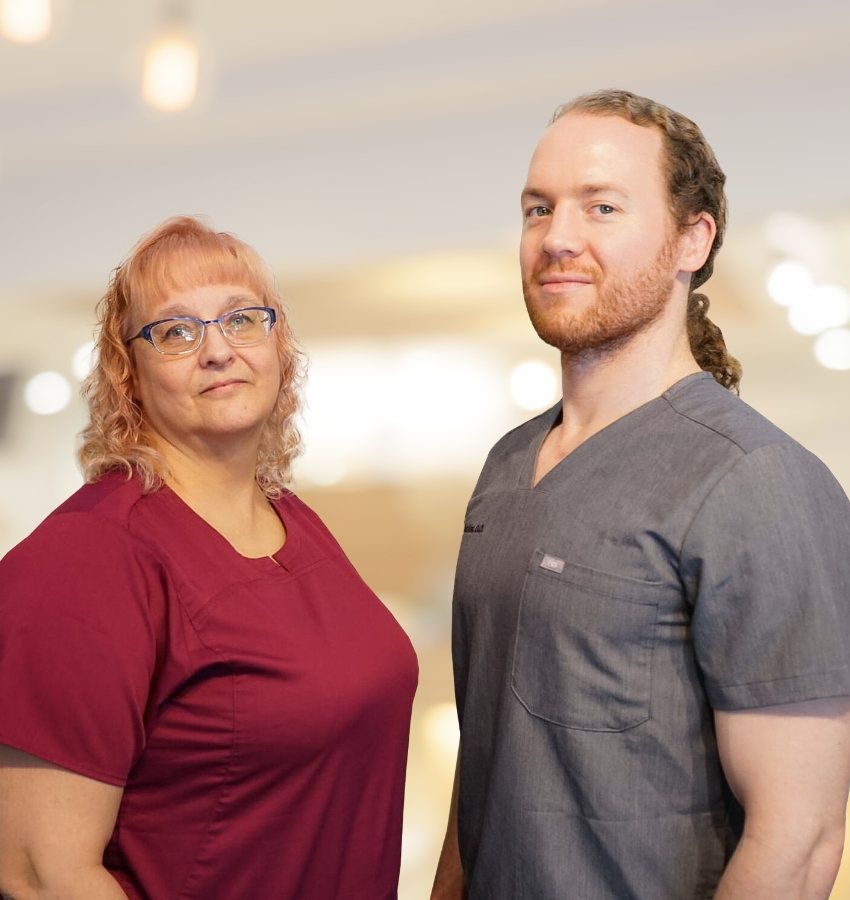 Doctor Pinkston standing next to one of his team members