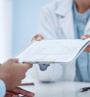 Medical team member giving clipboard to patient