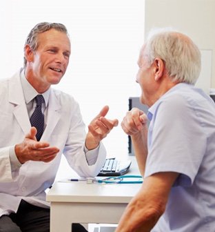 Doctor and patient conversing during consultation