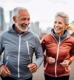 Older couple jogging outside