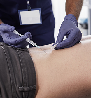 Physician placing trigger point injection in patient's back