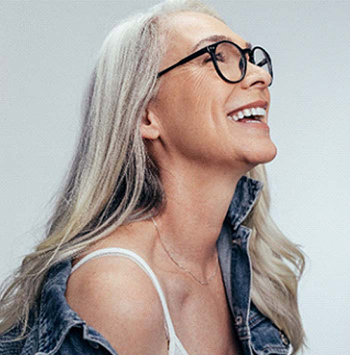 older woman with long gray hair smiling
