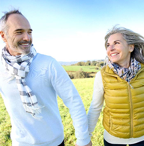 smiling mature couple walking outside