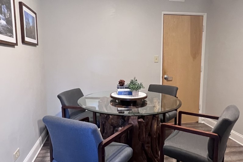 Glass table surrounded by four chairs
