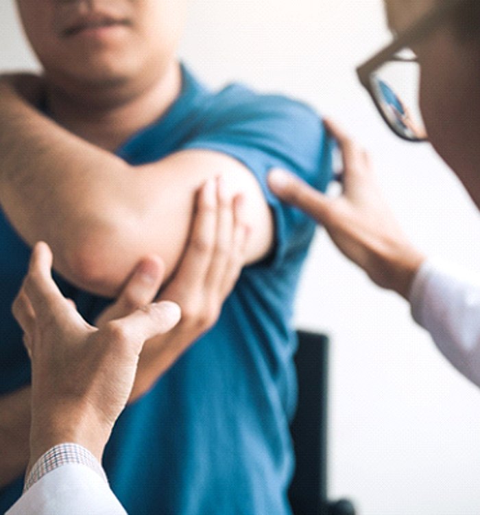 doctor holding man’s shoulder 