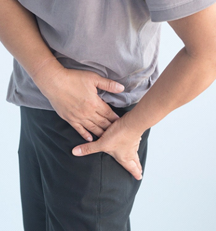 man holding hip due to osteoarthritis 