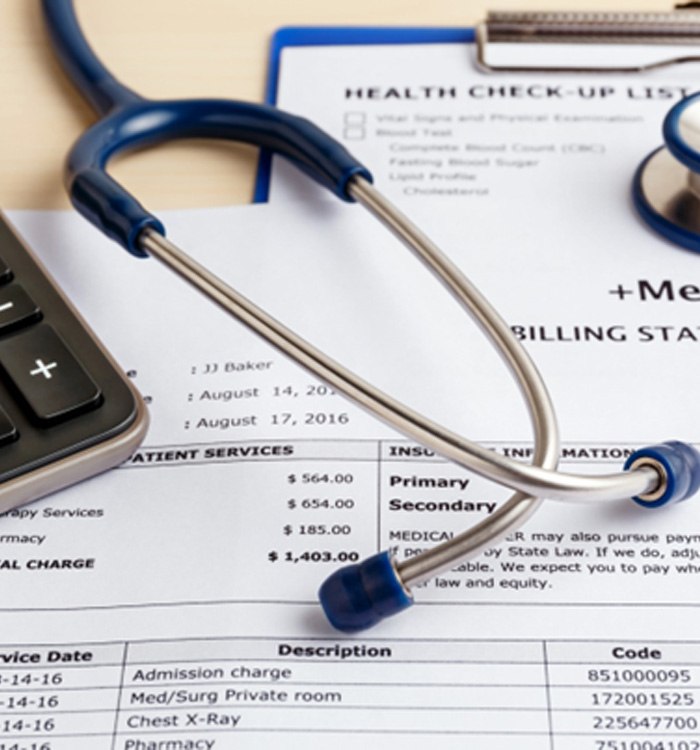 Medical billing statement with calculator and stethoscope