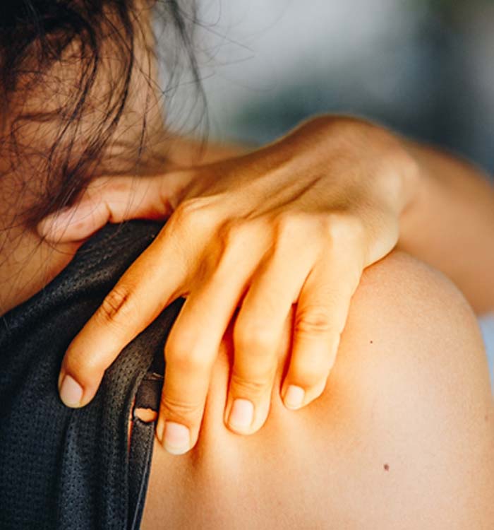 woman holding shoulder due to rotator cuff tear 