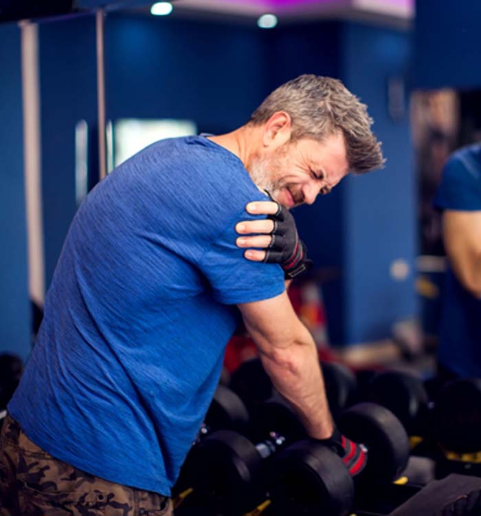 man with hurting shoulder lifting weights 