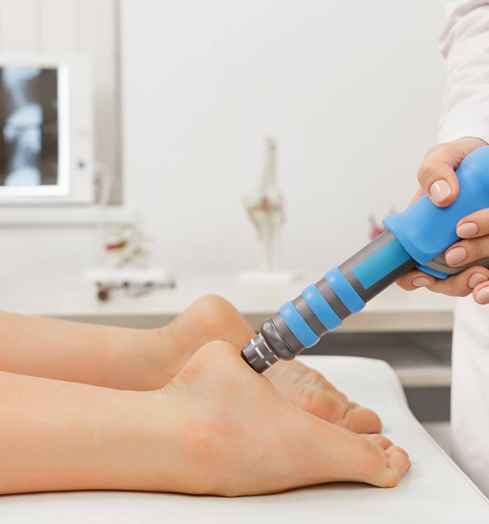 Patient receiving shockwave therapy for foot