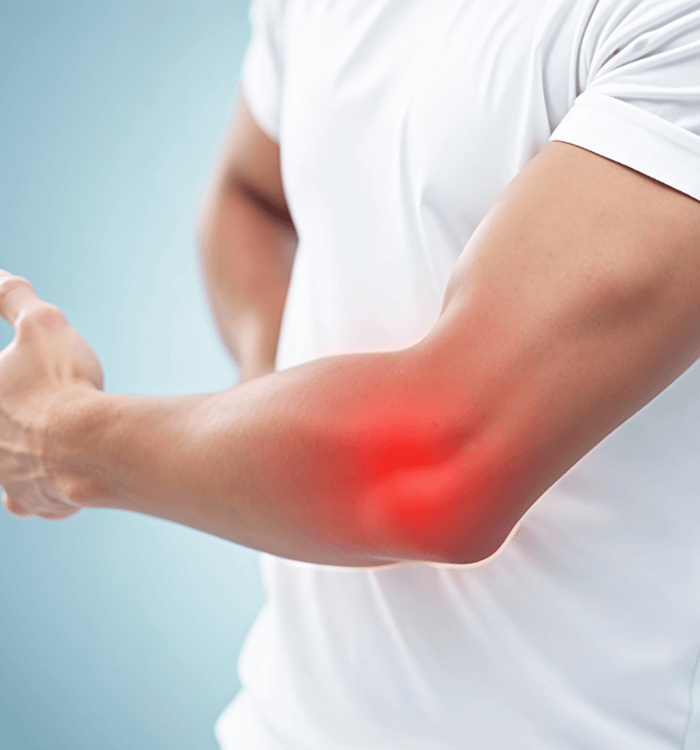 Man in white t-shirt experiencing elbow pain