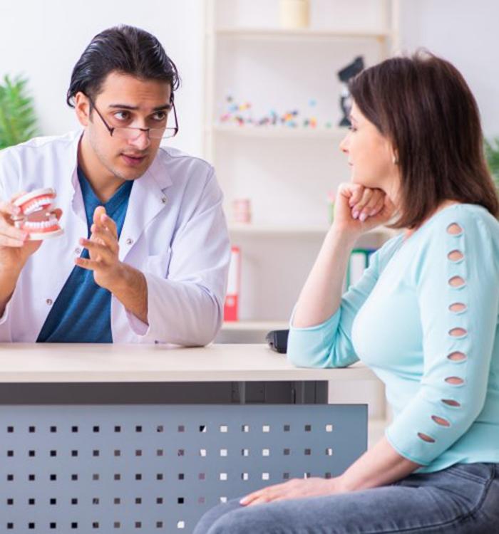 Physician discussing treatment with female patient