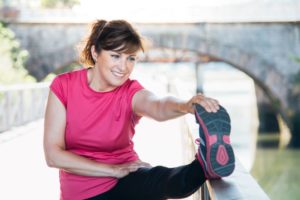Woman smiling and stretching, enjoying benefits of biologic cell therapy