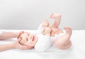 Happy baby undergoing cranial osteopathy