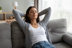 Woman relaxing on sofa after OMT session