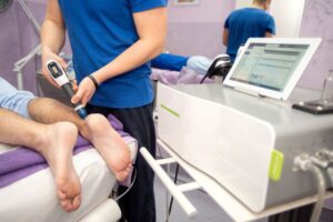 Man receiving shockwave therapy for his Achilles tendon 