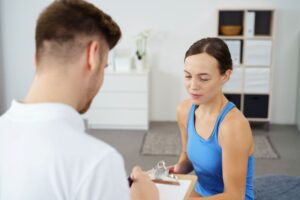 Medical team member taking notes during patient consultation 