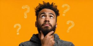 Man wearing thoughtful expression, question marks around his head 
