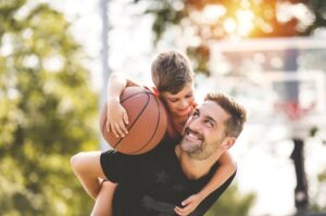 Father and son playing basketball 